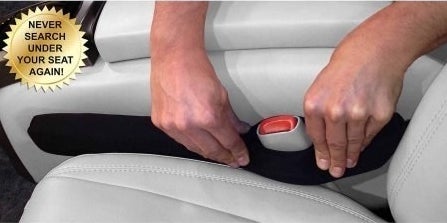 The seat gap filler being placed between the car seat and the center console