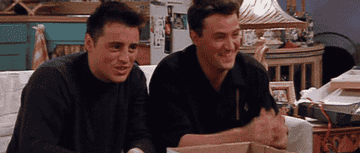 gif of joey and chandler smiling and doing finger guns
