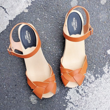 The sandals in an orange color with a beige footbed