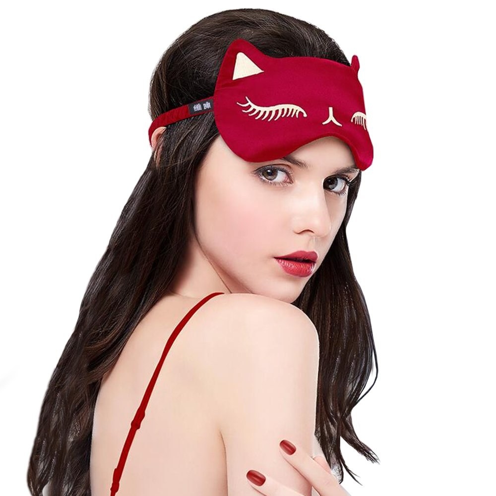 person wearing red cat eye sleep mask 