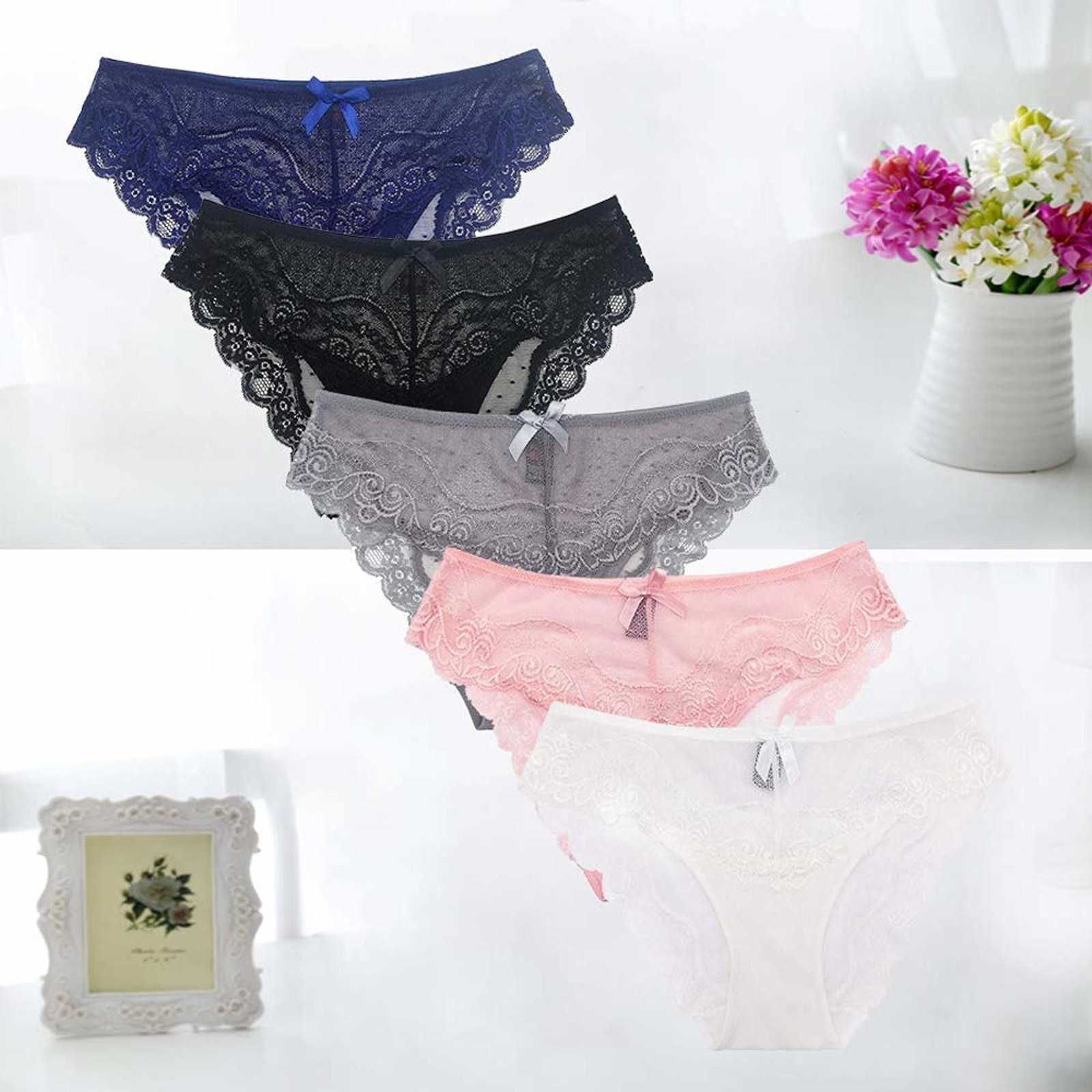 five pairs of underwear in blue, black, gray, pink, and white