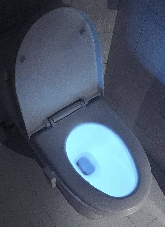 A toilet glowing blue 