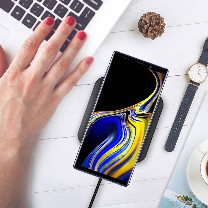 A phone placed on the charging pad