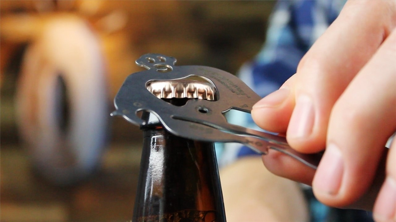 Model using the tool to open a bottle
