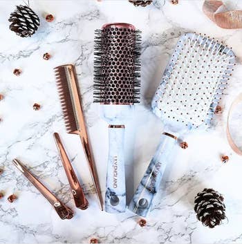 the marble print round and paddle brushes, and the rose gold comb and clips
