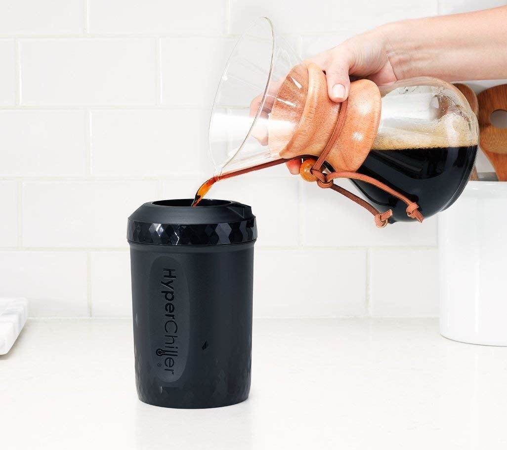 Model pours coffee into the device