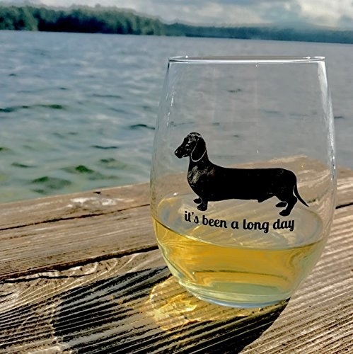 The wine glass that says &quot;it&#x27;s been a long day&quot; under an illustration of a dachshund