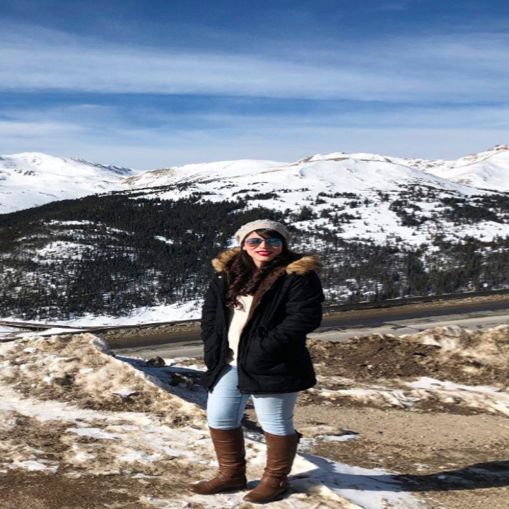 reviewer wearing jacket outside in the mountains with snow
