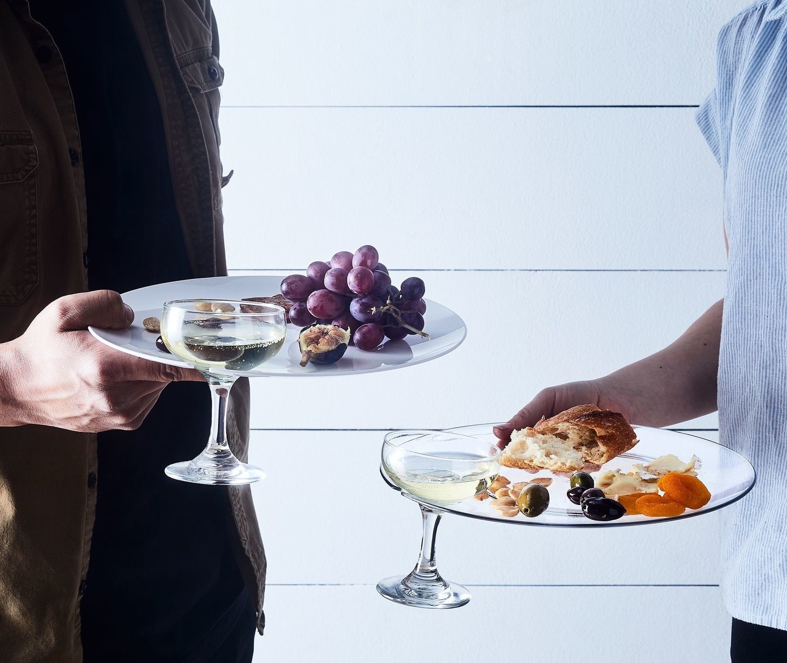 People holding plates with built-in slots for stemware 