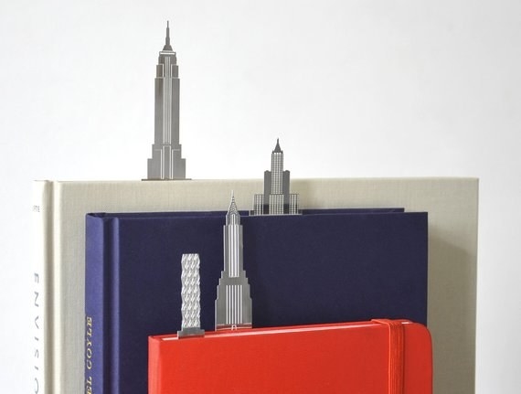 three books with skyscraper-look bookmarks marking pages