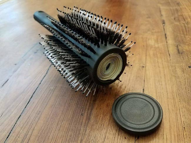 round hairbrush with part inside for stashing cash