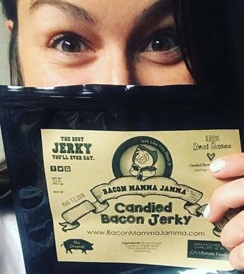 Person holding jerky package in front of face 