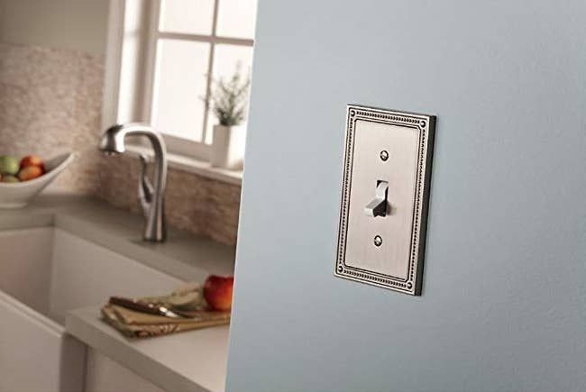 Franklin Brass outlet cover in a satin nickel color and detailed edge