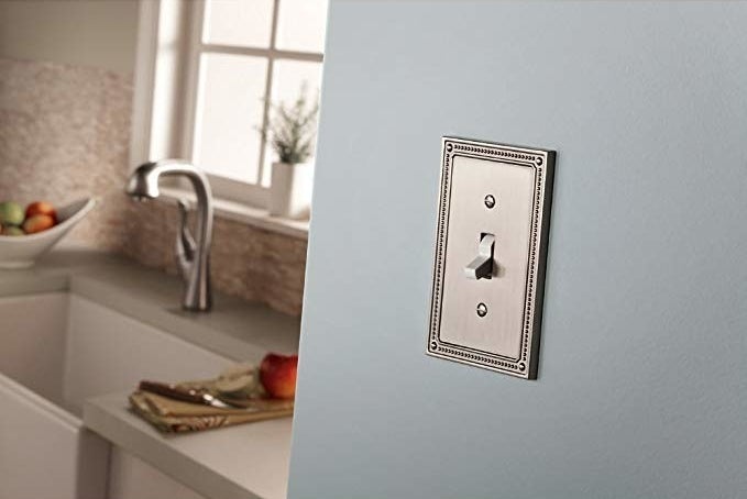 Outlet cover in a satin nickel color and detailed beaded edge