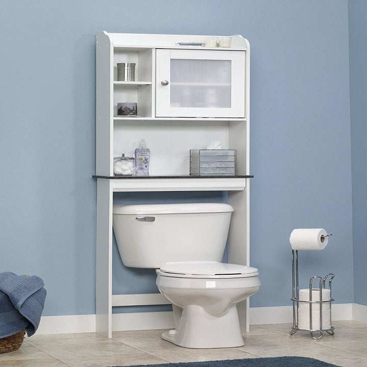 The shelf with tissues and other bathroom items on it
