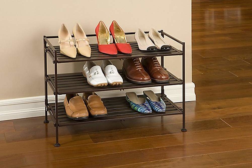 A three-tier shoe rack with seven pairs of shoes on it