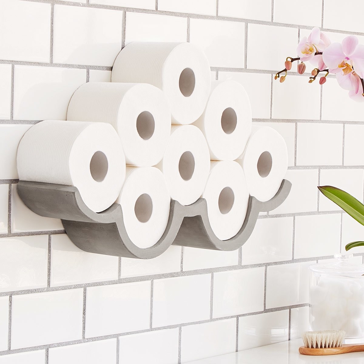 The cloud-shaped wall-mounted shelf with toilet paper rolls on it