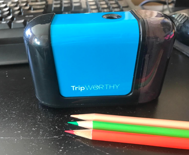 A reviewer&#x27;s sharpener next to some very sharp colored pencils