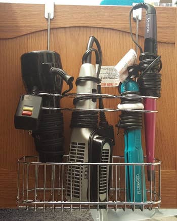 a bathroom cabinet door organized with the over-cabinet hair care station