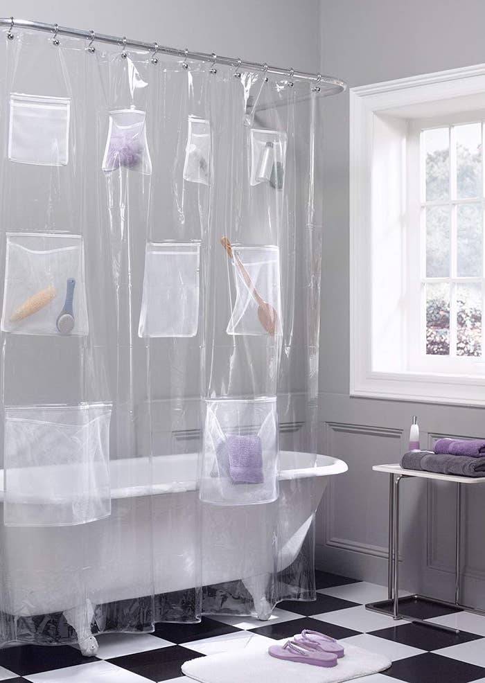 The shower curtain with toiletries in the pockets