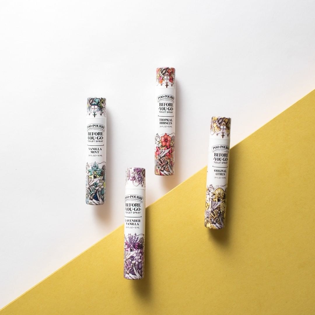 four small cylindrical bottles of poo-pourri 