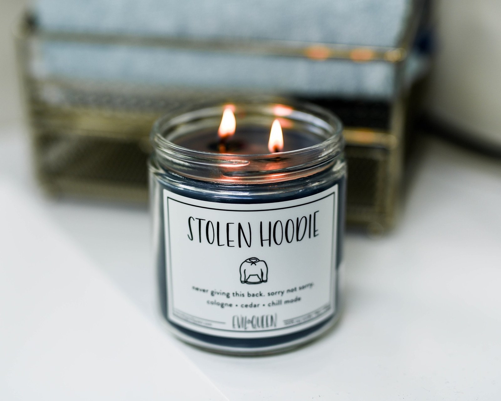 a candle with a label that says &quot;stolen hood, never giving this back, sorry not sorry&quot; on it