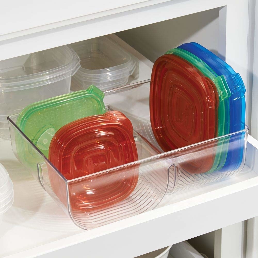 Promising review: "A bit pricey for a plastic bin to put my plastic lids into, but it's a perfect size and it's not flimsy! Instantly made my plasticware drawer less frustrating! :) I used museum putty (sticky tack) to help it not slide around." —EmmyGet it from Amazon for $12.99.