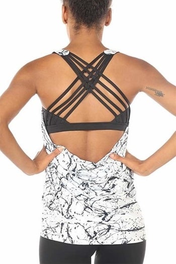 Back view of top on model showing the strappy bra back of the black and white marbled tank