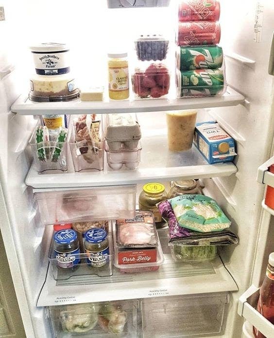Reviewer photo of a neatly organized fridge that utilizes the storage bins