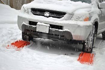 A car using the tracks on snow