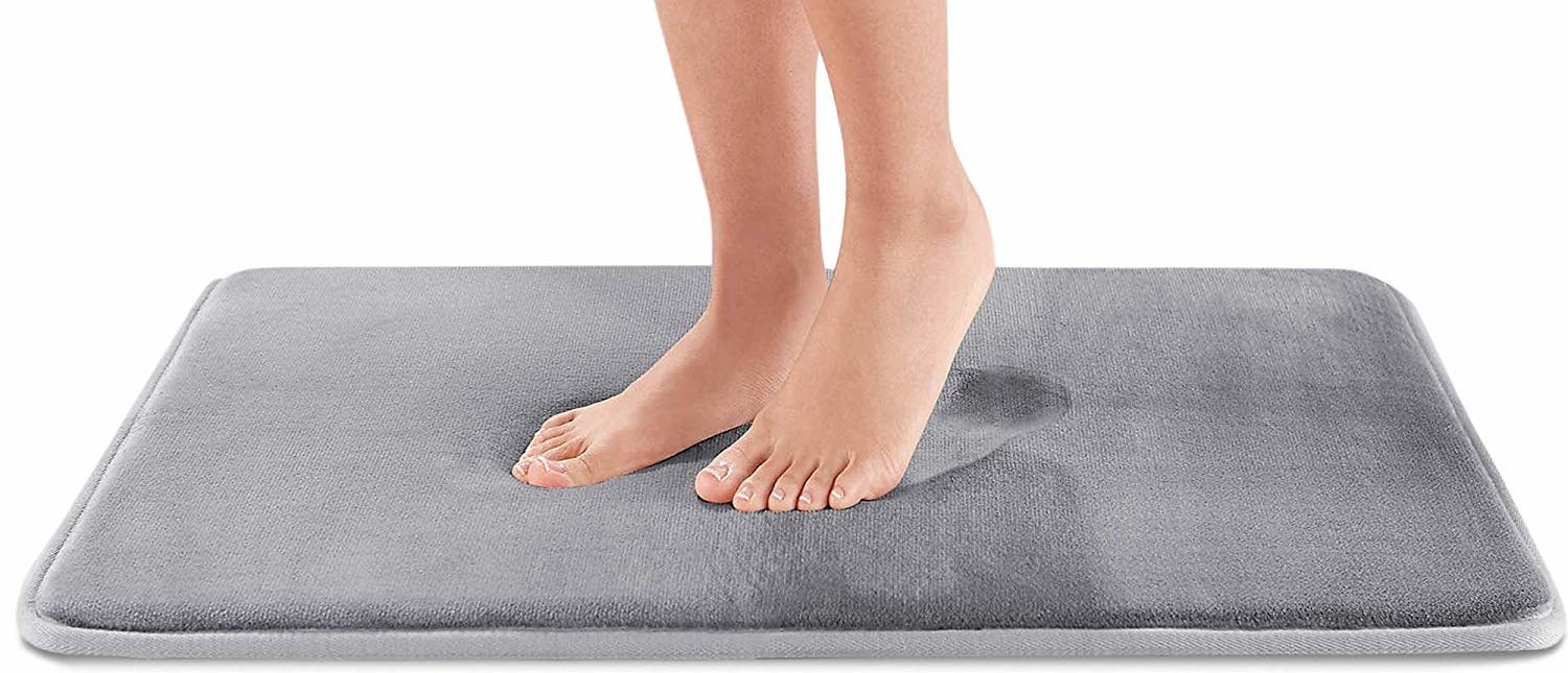 feet on grey squishy bathmat