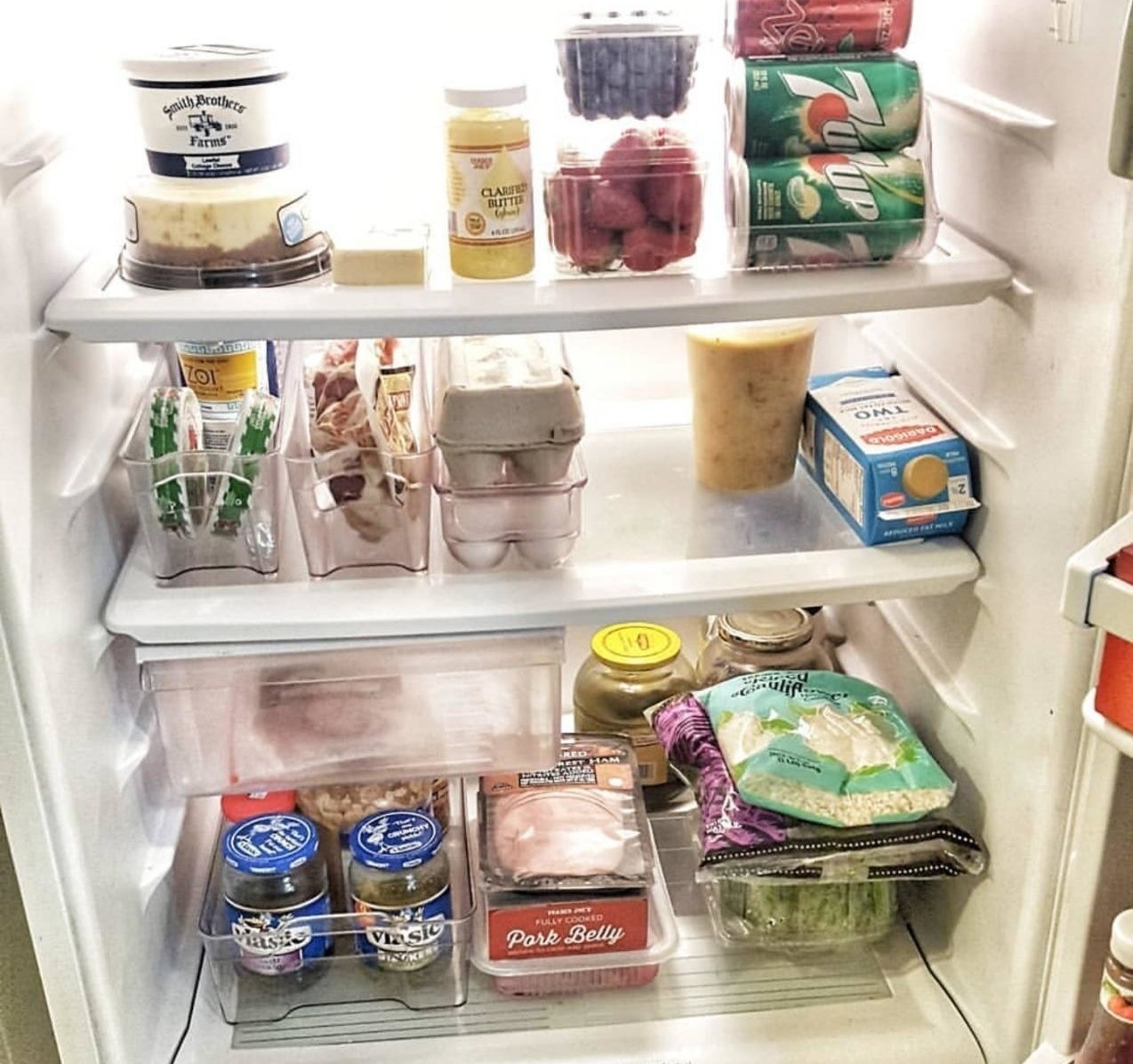 a refrigerator with its contents neatly organized in clear bins