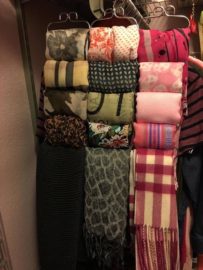 reviewer photo of the organizer holding fifteen scarfs