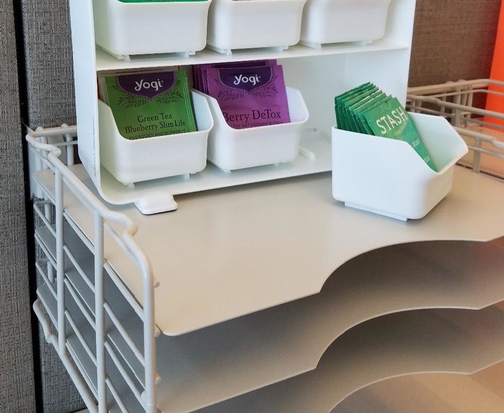 the white draw set with each compartment holding packages of tea