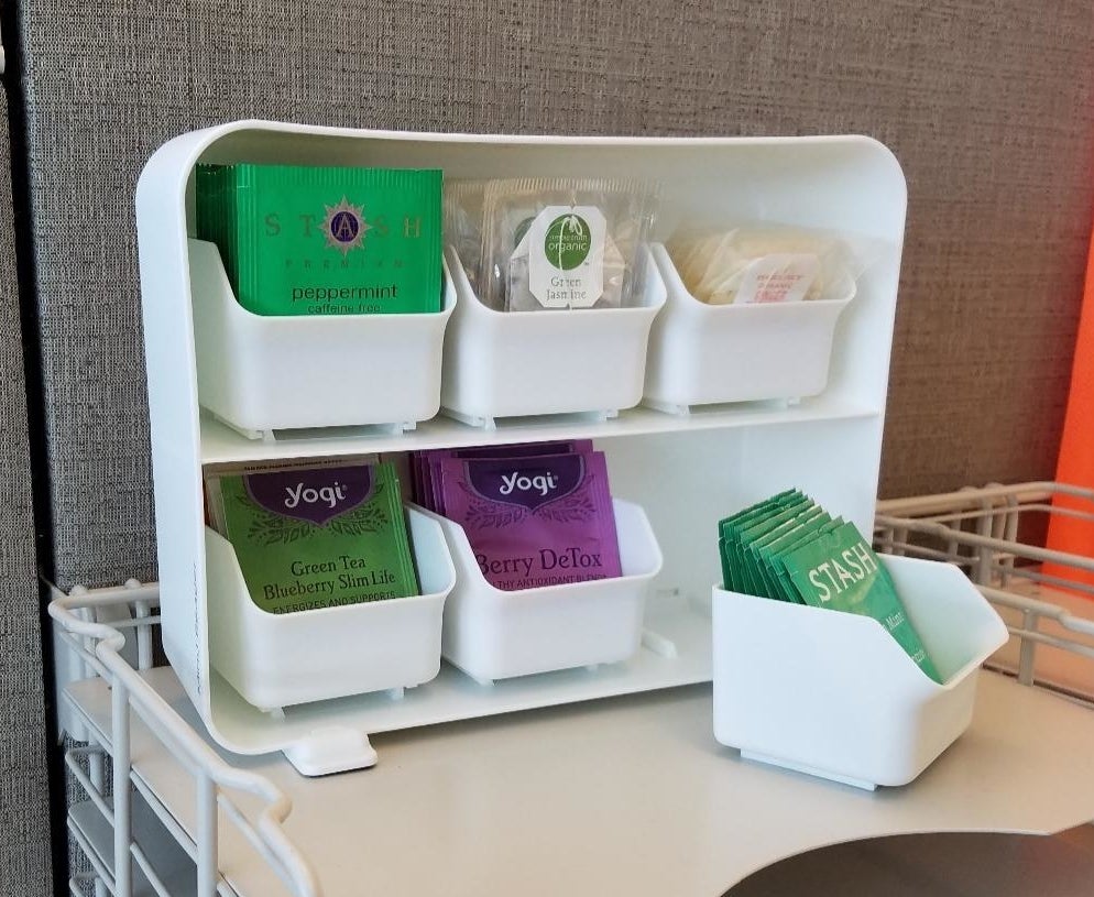 the white draw set with each compartment holding packages of tea