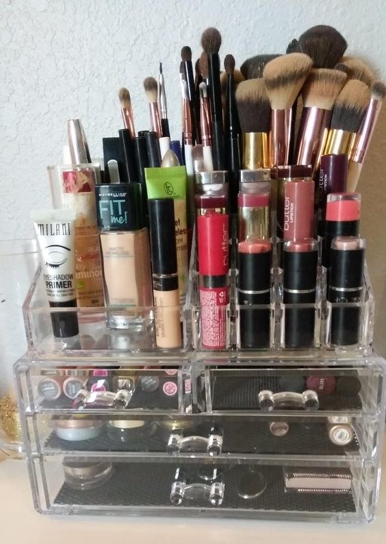 clear acrylic organizer with two big drawers, two small drwers, and spaces for lipsticks, taller products, and brushed on top