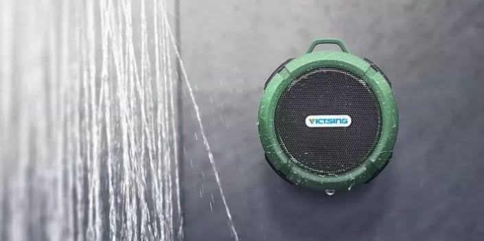 round green speaker on shower wall