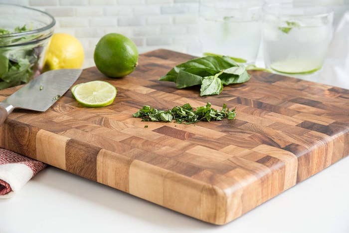 A thick cutting board with a mixed wood pattern 