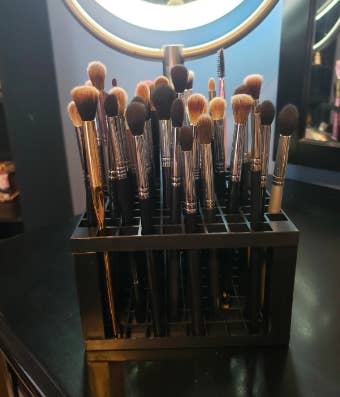 A different review image where the reviewer has placed several makeup brushes in the cube 