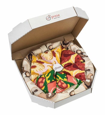 pizza box filled with socks rolled into shape of pizza slices