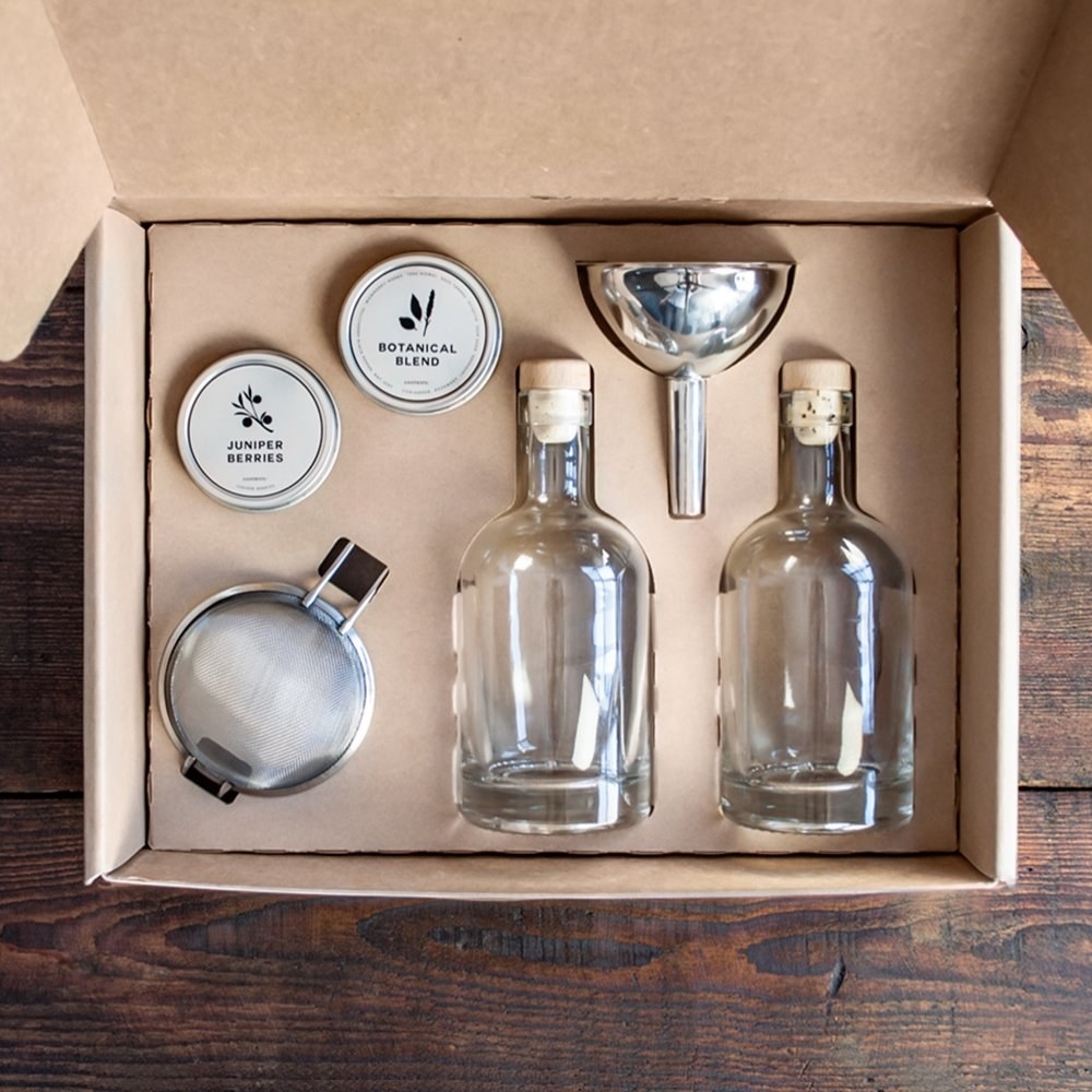 the kit with two clear bottles, a funnel, blends of spices, and strainer