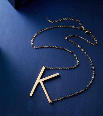 large gold k pendant on a necklace
