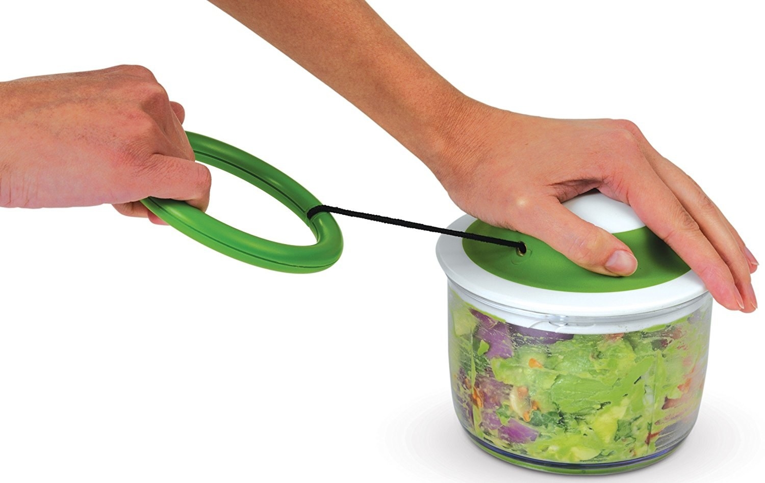 Someone using the green food chopper to slice leafy greens