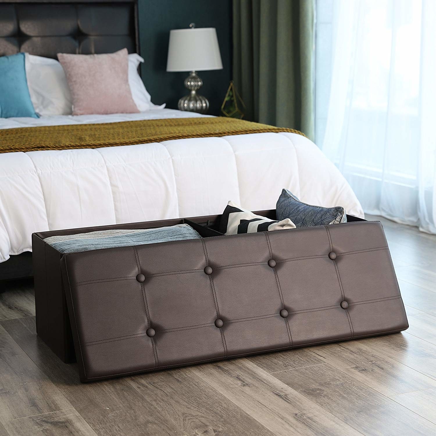 A brown rectangular storage bench with a tufted, removable top 