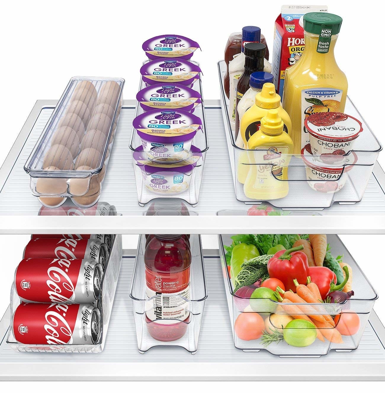 A refrigerator organized with different sized clear storage bins 