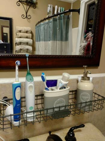 one of the baskets hung above a sink, with toothbrushes and soap on it
