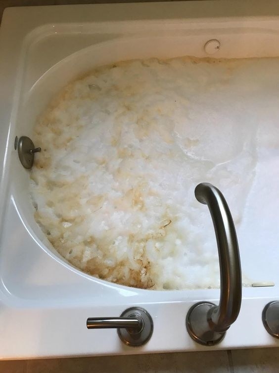 reviewer&#x27;s jetted tub full of bubbles and brown goo that came out of them during cleaning