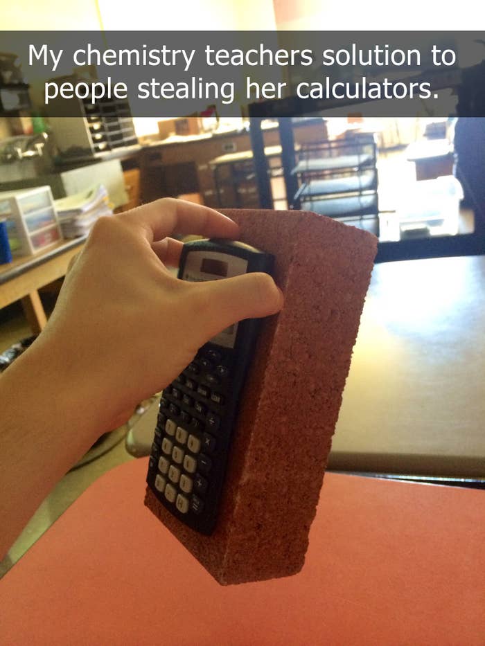 A hand holding a brick with a calculator attached to it in a classroom setting. Text on the image reads, "My chemistry teacher's solution to people stealing her calculators."