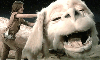 A shot from The NeverEnding Story where Atreyu is petting Falkor 