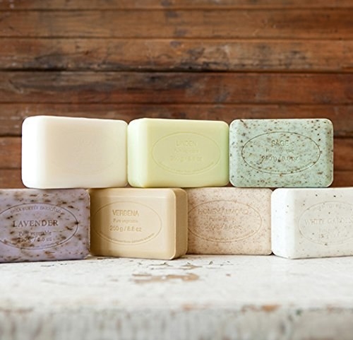 A variety of Pre de Provence Artisanal French soap bars stacked on top of each other